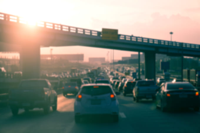Car traffic against the sunset background.