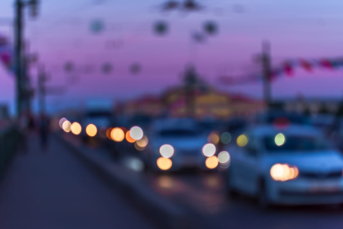 Abstract defocused image of cars driving at dusk