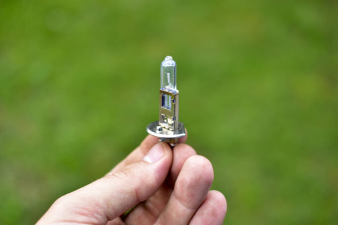 Car low-beam and high-beam light bulbs in your hands